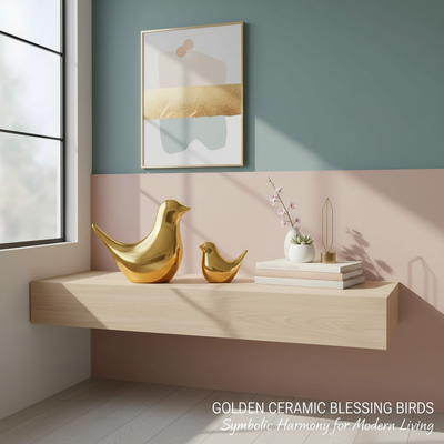 Two golden ceramic bird figurines with smooth curves, placed on a modern minimalist shelf in a well-lit living room.